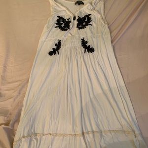 White dress with navy stitched flowers